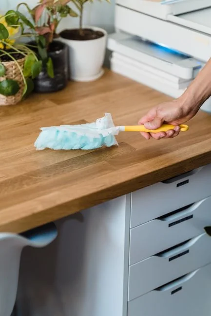 about-02 Anonymous person in yellow rubber gloves using simple sponge for cleaning mirror in bathroom